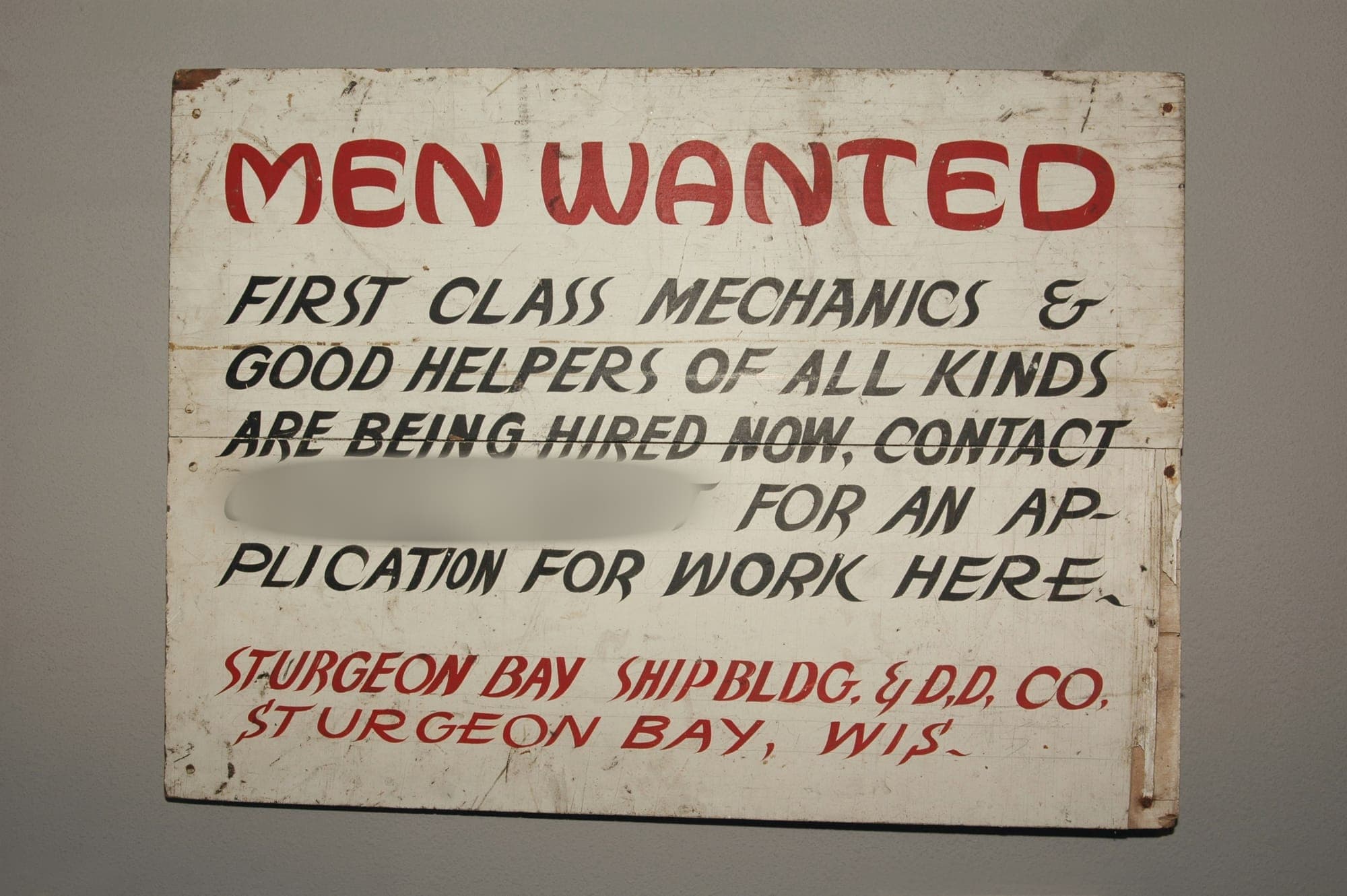 Image of a public sign that has contact details blurred by BlurMe